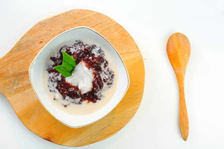Thai style dessert, Black sticky rice with coconut milk in white bowlの写真素材