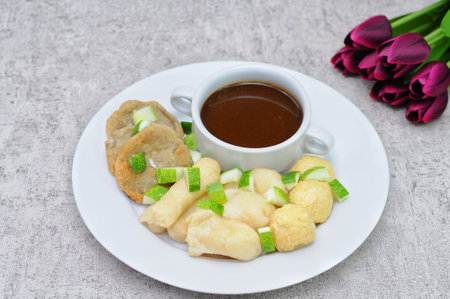 Pempek Palembang, traditional food from South Sumatra, Indonesia. This fish-based food is very popular. Served with cuko sauce and cucumber slices.の写真素材