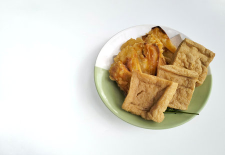 Thai style fried tofu with sweet and sour sauce on white background