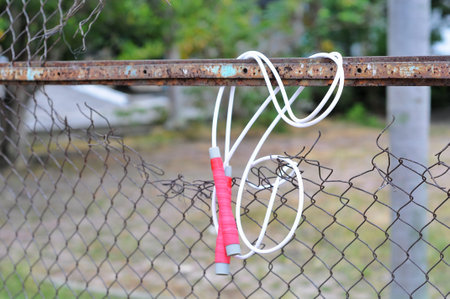 Jumping rope attached to the fence, closeup of photo.の写真素材