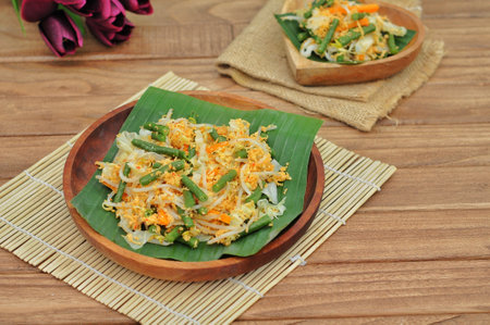Thai style fried noodle with egg and vegetable in banana leafの写真素材