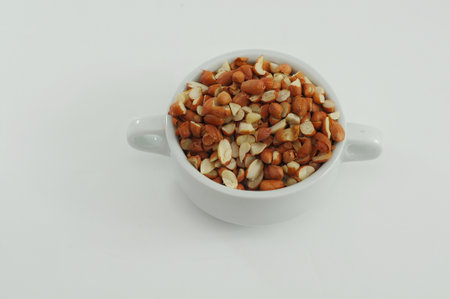 chopped raw peanuts in a white bowl