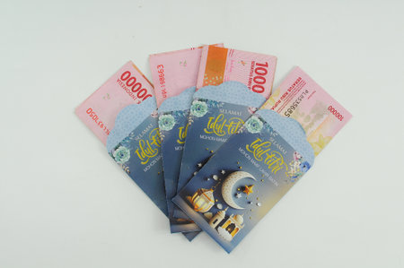 Indonesian currency in an envelope with Islamic motifs for holiday allowance