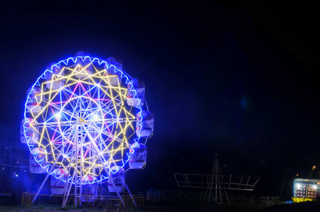Ferris wheel in the park at night, closeup of photoの写真素材