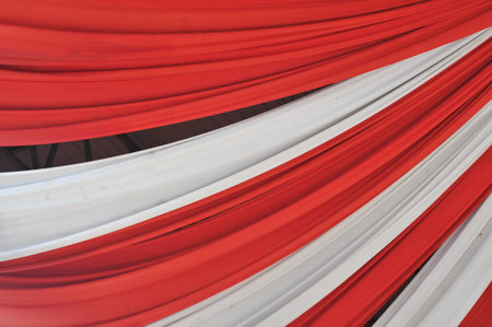 Red and white fabric curtain on stage in a concert or theater.の写真素材