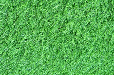 Green artificial grass texture or background. Green artificial grass for soccer field.の写真素材