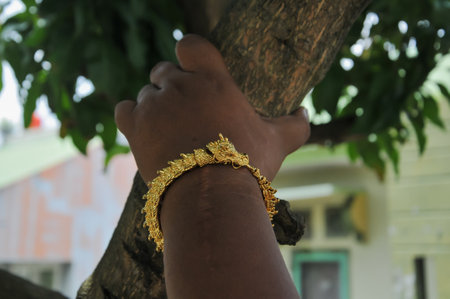 Close up of indian woman's hands with gold bracelets.の写真素材