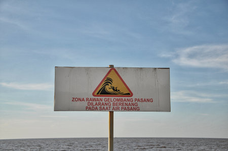 Warning sign on the beach of the Baltic Sea in Poland, Europe.の写真素材