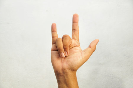 Female hand showing peace sign on a white background with copy space.の写真素材