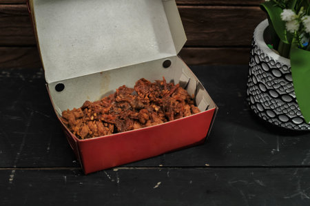 Crispy fried chicken in a box on a black background.の写真素材