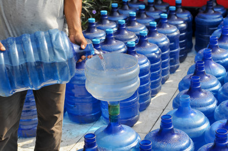 Plastic bottles for drinking water on the street, closeup of photoの写真素材