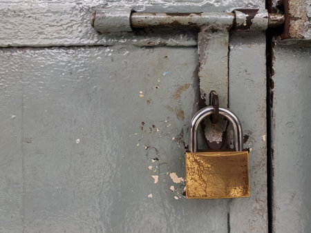 Padlock on an old metal door, closeup of photo.の写真素材