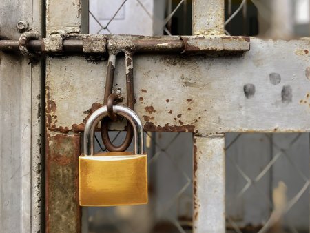 Old padlock on a rusty metal door, closeup of photoの写真素材