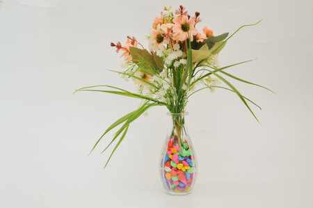 Bouquet of flowers in glass vase on white background.の写真素材