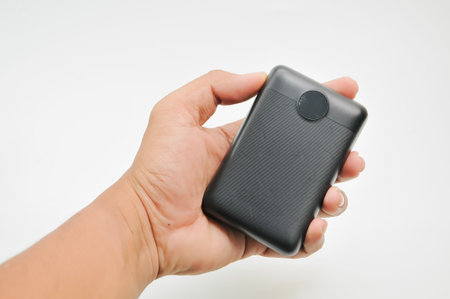 Smartphone in hand on a white background. Close-up.の写真素材