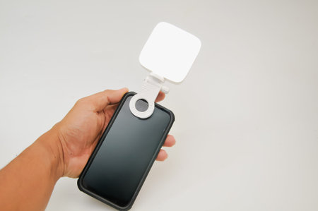 Smartphone with blank screen in hand on white background, stock photoの写真素材