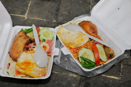 Fried rice with chicken and fried egg in take away food boxの写真素材