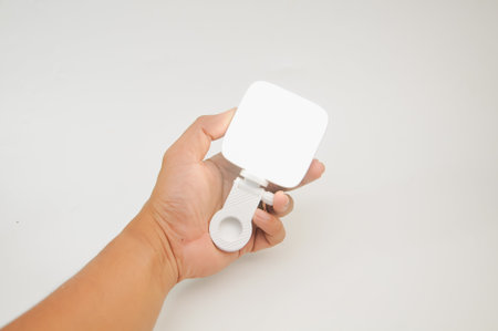 Hand holding a white object isolated on white background, clipping pathの写真素材