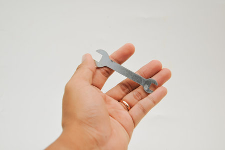 Spanner in hand isolated on white background with clipping path.の写真素材
