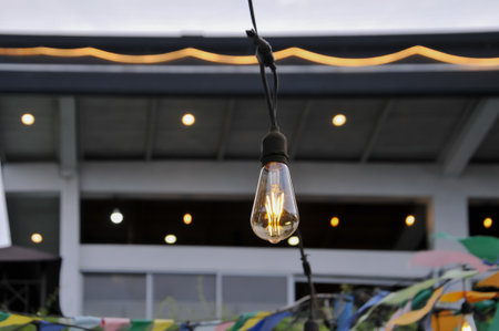 Vintage light bulb hanging in the street. Retro light bulb.