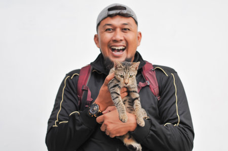 Portrait of man holding a cat in his hands isolated on white background