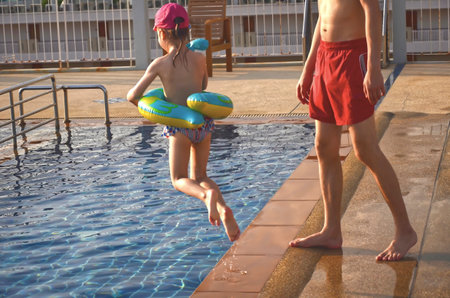 Little boy and his father having fun at the swimming pool. summer vacation conceptの写真素材