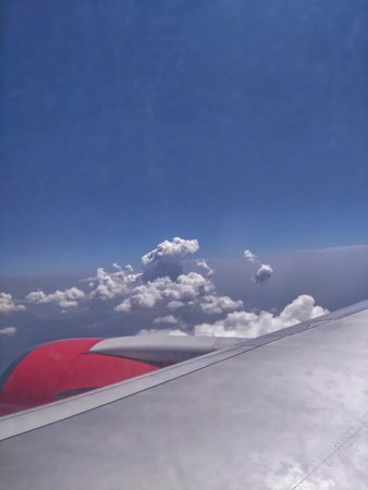 Clouds and blue sky as seen through window of an aircraft.の写真素材