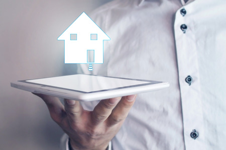Man holding house. Real estate concept.の写真素材