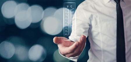 Businessman holding thermometer.の写真素材