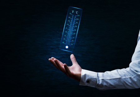 Hand holding thermometer.の写真素材
