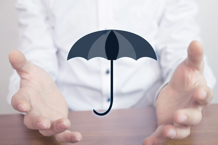 Man holding umbrella. Protection concept.の写真素材