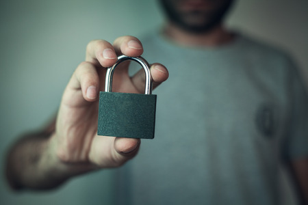 Man holding lock. Security concept.の写真素材