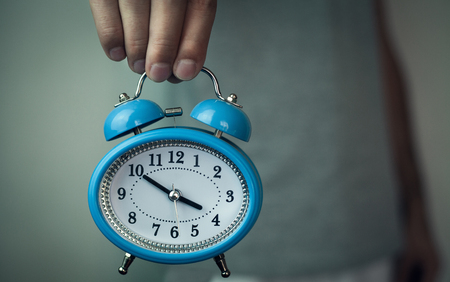 Man holding alarm clock.の写真素材
