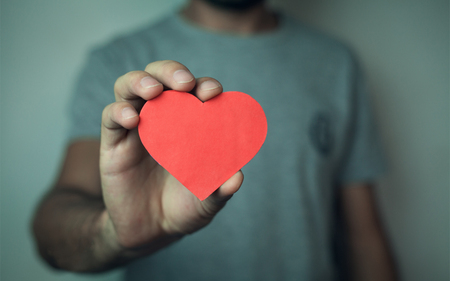 Man holding red heart. Love concept.の写真素材