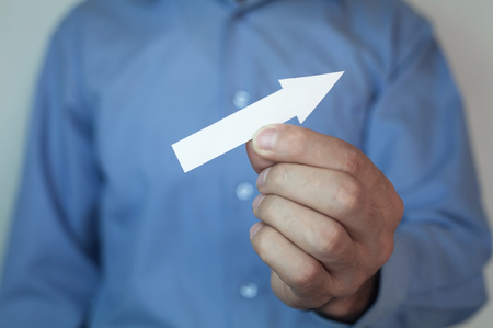 Businessman holding arrow.
