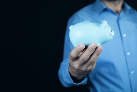 Man holding piggy bank.の写真素材