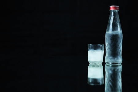 Cold vodka on a black background.の写真素材