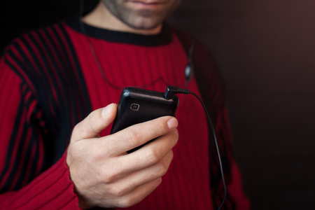 Man listening music with earphones.の写真素材