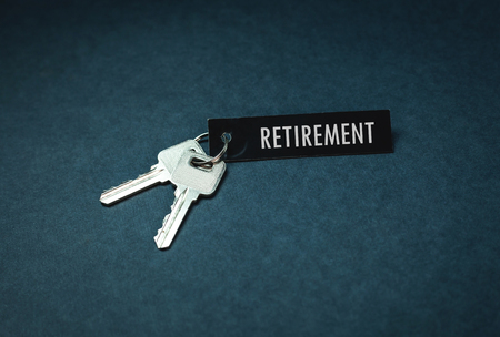 Key and retirement word on a blue background.