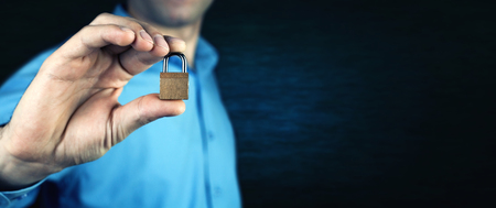 Man holding lock. Security conceptの写真素材