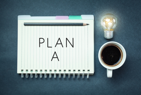 Plan a on notepad on a blue background.の写真素材