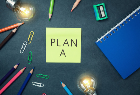 Plan a on note on a blue background.の写真素材