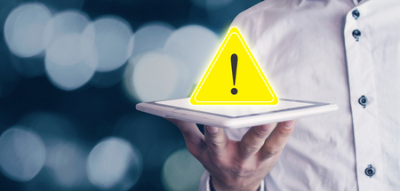 Man holding warning sign.の写真素材