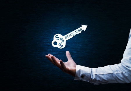Man holding success key. Solution conceptの写真素材