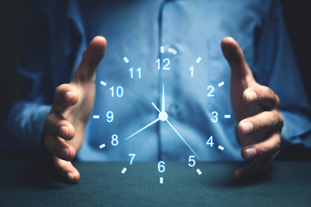 Businessman showing clock. Concept of saving time.