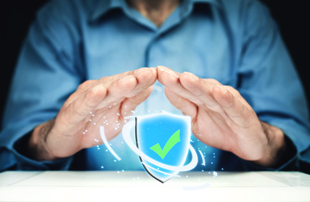 Man hands with shield security sign.の写真素材
