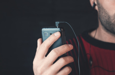 Man listening music with earphones.の写真素材