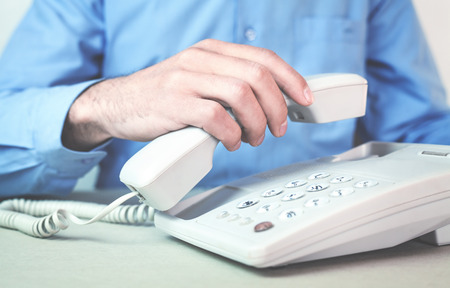 Caucasian man with a fixed telephone.の写真素材