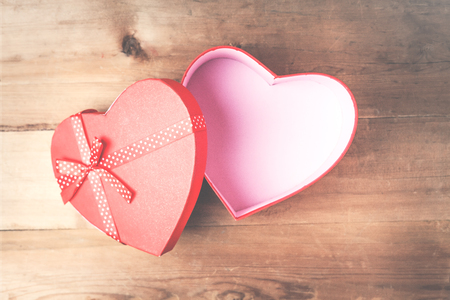 Red heart box on a wood background.の写真素材