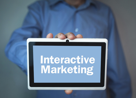 Businessman showing text interactive marketing on a digital tablet.の写真素材